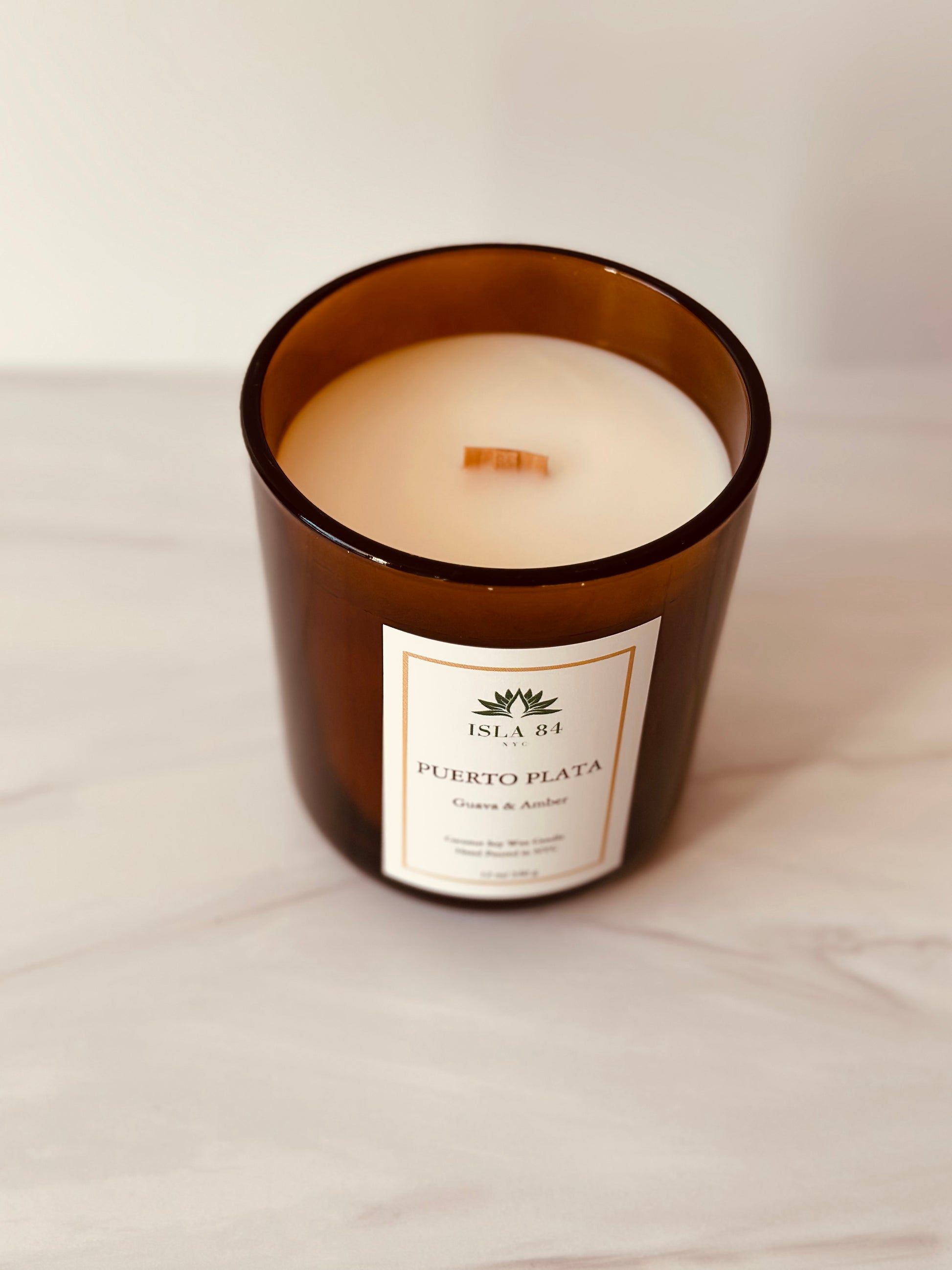 A photograph of Puerta Plata Scented Candle on cream background
