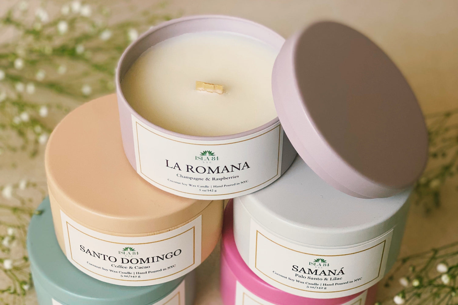 Dominican-inspired coconut soy wax candles by Isla 84 NYC in colorful tins.