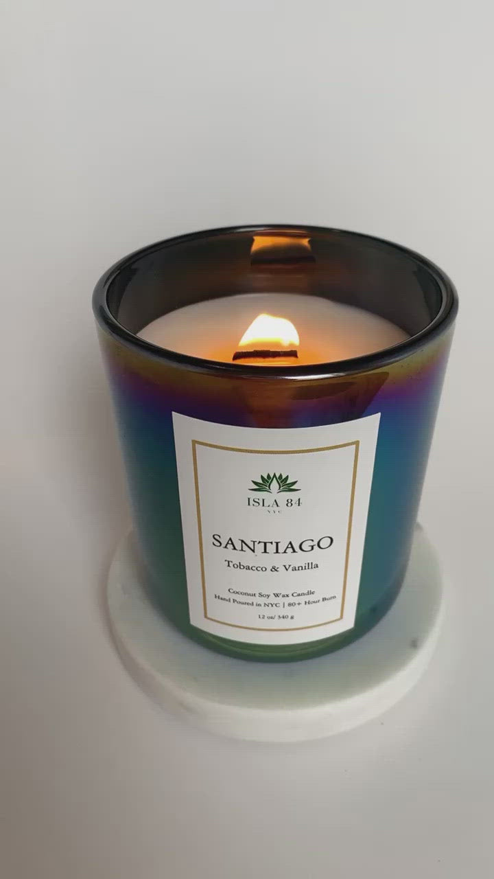 Santiago Signature Scented Candle; Tobacco & Vanilla; Iridescent Black, green vessel; White label with green logo; Dominican Republic Candels; DR Candles; Coconut Soy Wax Candle with Wood Wick; Burning Wood Wick