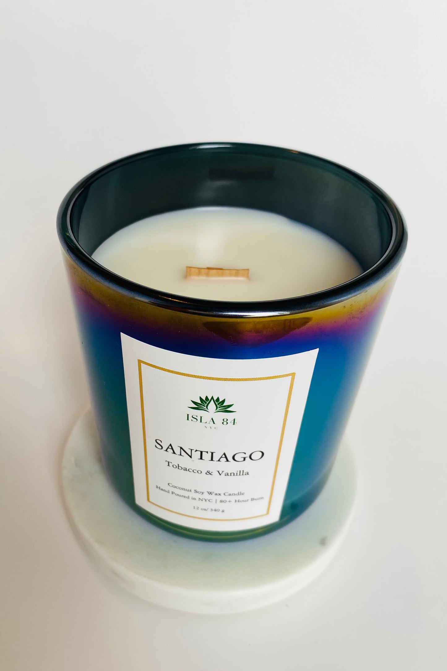 Santiago Signature Scented Candle; Tobacco & Vanilla; Iridescent Black, green vessel; White label with green logo; Dominican Republic Candels; DR Candles; Coconut Soy Wax Candle with Wood Wick